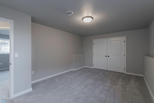 unfurnished bedroom featuring baseboards and carpet