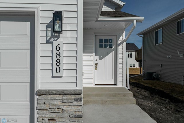 doorway to property featuring central air condition unit