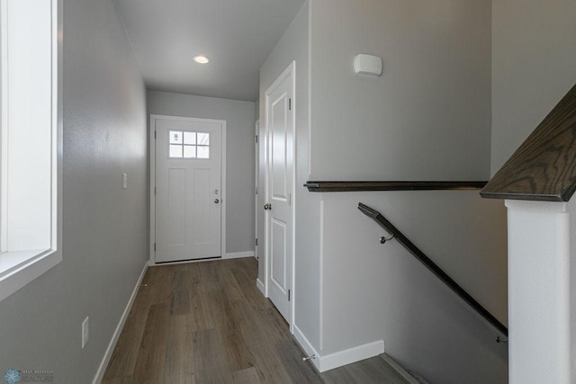 entryway with wood finished floors, baseboards, and recessed lighting