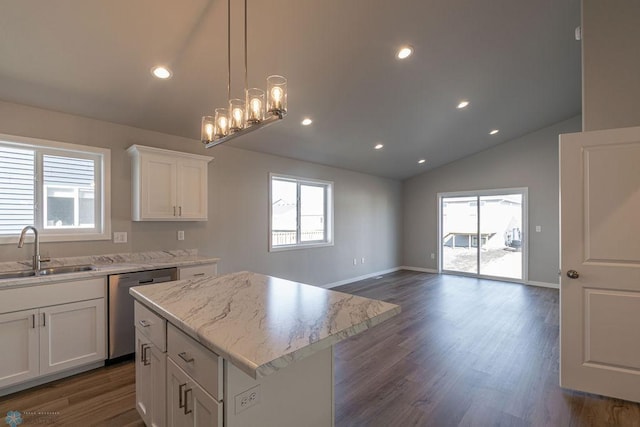 kitchen featuring a sink, stainless steel dishwasher, a wealth of natural light, and white cabinets