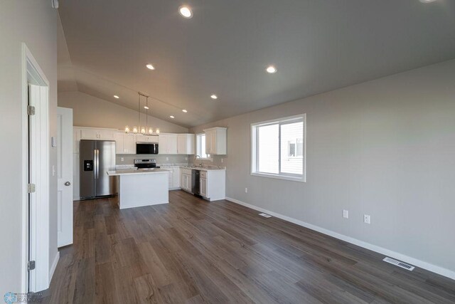 kitchen featuring white cabinetry, visible vents, appliances with stainless steel finishes, and vaulted ceiling