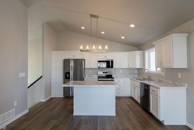 kitchen featuring dark wood-style flooring, vaulted ceiling, visible vents, stainless steel appliances, and a sink