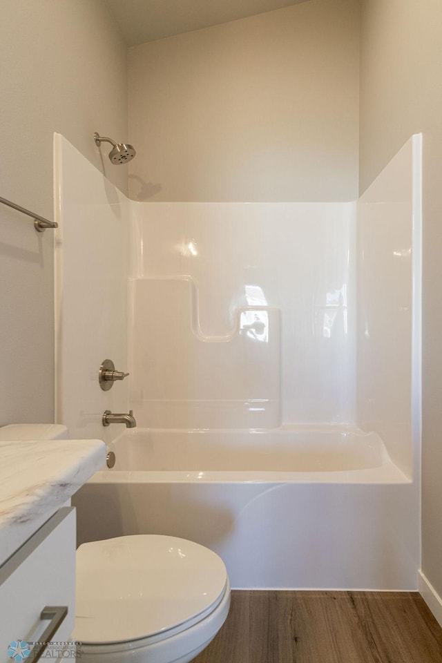 full bath with vanity, shower / bathing tub combination, toilet, and wood finished floors