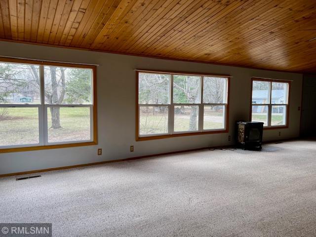 unfurnished room with wooden ceiling, visible vents, and carpet floors