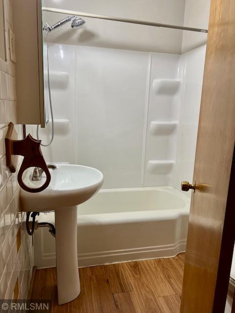 full bathroom featuring shower / washtub combination and wood finished floors