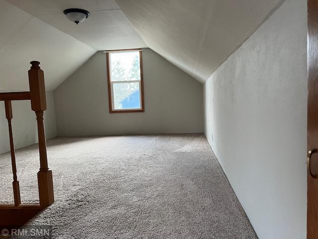 bonus room featuring carpet and lofted ceiling