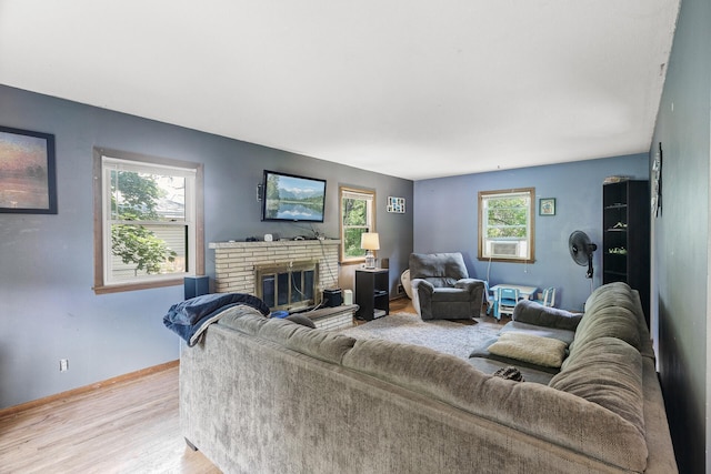 7716 Orchard Ave N, Brooklyn Park, MN 55443 - living area with light wood-style flooring, a brick fireplace, and baseboards