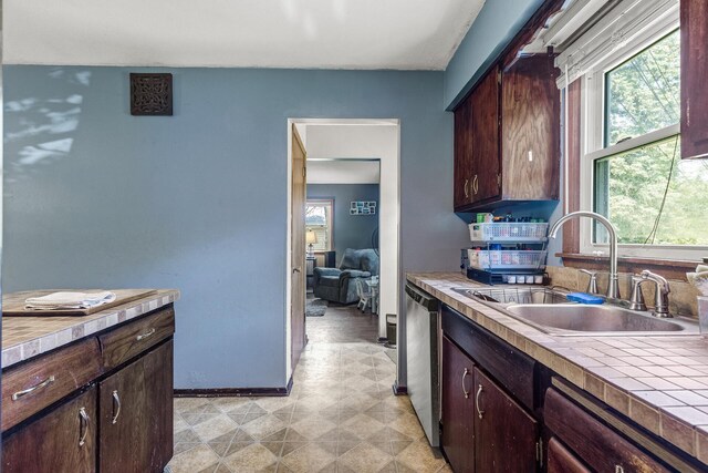 7716 Orchard Ave N, Brooklyn Park, MN 55443 - kitchen featuring a sink, dishwasher, dark brown cabinets, baseboards, and light flooring