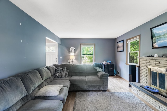 7716 Orchard Ave N, Brooklyn Park, MN 55443 - living room with wood finished floors, healthy amount of natural light, and a fireplace