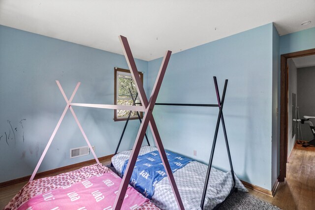 7716 Orchard Ave N, Brooklyn Park, MN 55443 - unfurnished bedroom with wood finished floors and baseboards