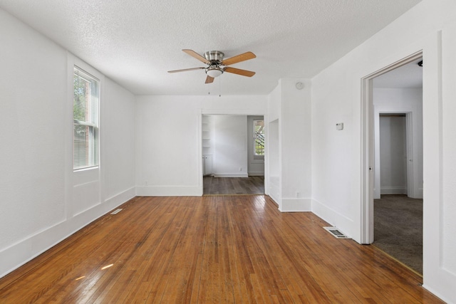 1208 University Ave NE, Minneapolis, MN 55413 - unfurnished room featuring ceiling fan, hardwood / wood-style flooring, a textured ceiling, and baseboards