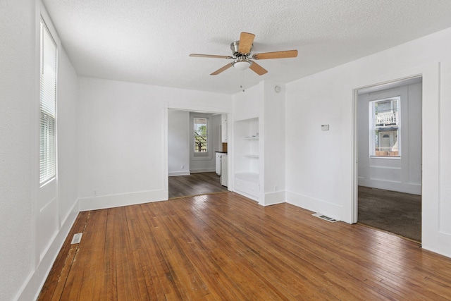 1208 University Ave NE, Minneapolis, MN 55413 - unfurnished room with built in features, ceiling fan, hardwood / wood-style flooring, a textured ceiling, and baseboards