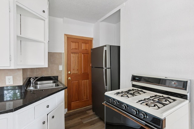 1208 University Ave NE, Minneapolis, MN 55413 - kitchen featuring white range with gas cooktop, a sink, freestanding refrigerator, white cabinets, and a textured ceiling