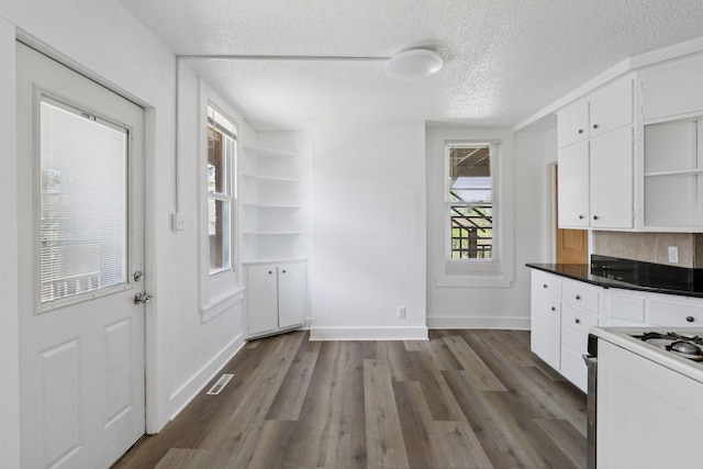 1208 University Ave NE, Minneapolis, MN 55413 - kitchen with open shelves, white cabinets, dark wood-style flooring, a textured ceiling, and white range with gas cooktop