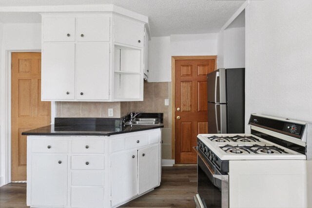 1208 University Ave NE, Minneapolis, MN 55413 - kitchen with white range with gas stovetop, freestanding refrigerator, a sink, dark wood finished floors, and white cabinets
