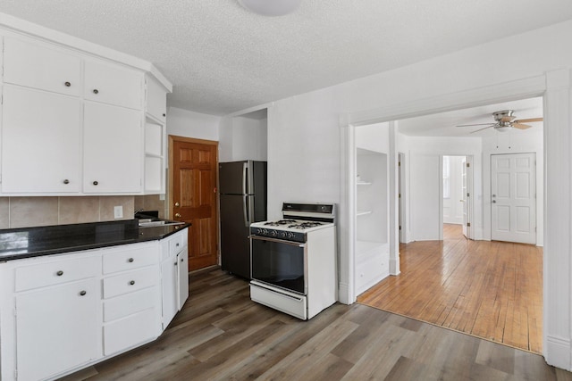 1208 University Ave NE, Minneapolis, MN 55413 - kitchen with range with gas cooktop, freestanding refrigerator, a sink, wood finished floors, and a textured ceiling
