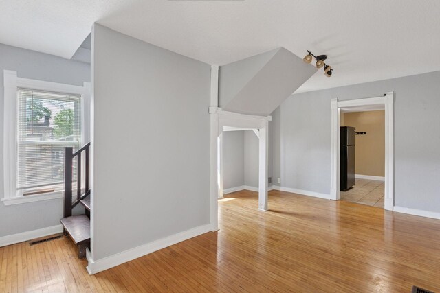 1208 University Ave NE, Minneapolis, MN 55413 - unfurnished living room featuring light wood finished floors and baseboards