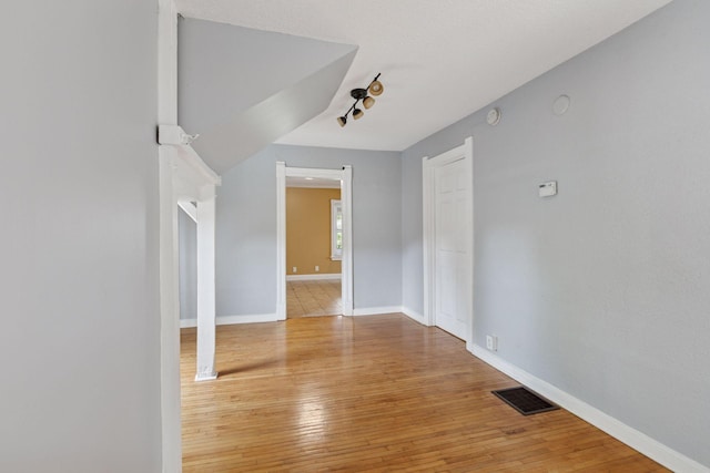 1208 University Ave NE, Minneapolis, MN 55413 - empty room with hardwood / wood-style floors, baseboards, and a smoke detector