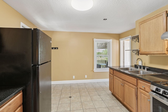 1208 University Ave NE, Minneapolis, MN 55413 - kitchen with freestanding refrigerator, a sink, dark countertops, a textured ceiling, and baseboards