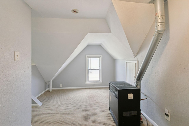 1208 University Ave NE, Minneapolis, MN 55413 - additional living space featuring heating unit, lofted ceiling, carpet flooring, and baseboards