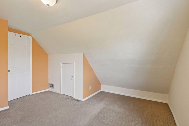 1208 University Ave NE, Minneapolis, MN 55413 - additional living space featuring carpet, vaulted ceiling, and baseboards