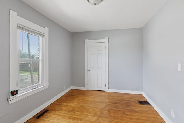 1208 University Ave NE, Minneapolis, MN 55413 - empty room featuring plenty of natural light, light wood finished floors, and baseboards