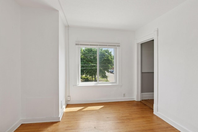 1208 University Ave NE, Minneapolis, MN 55413 - unfurnished bedroom with light wood-style floors and baseboards