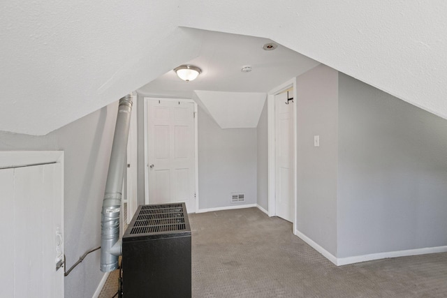 1208 University Ave NE, Minneapolis, MN 55413 - bonus room featuring carpet flooring, baseboards, vaulted ceiling, and heating unit