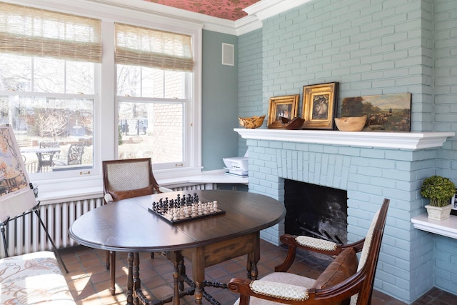 2774 Lake Of The Isles Pkwy, Minneapolis, MN 55416 - dining space with ornamental molding, radiator, and a brick fireplace