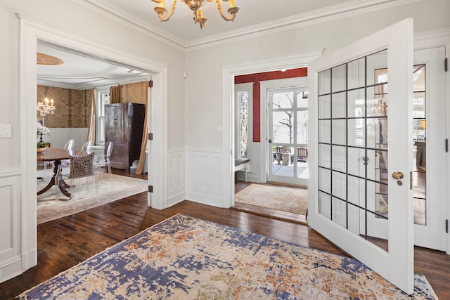 2774 Lake Of The Isles Pkwy, Minneapolis, MN 55416 - entrance foyer featuring a chandelier, wood finished floors, ornamental molding, a wainscoted wall, and a decorative wall
