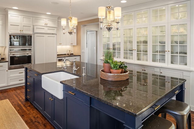2774 Lake Of The Isles Pkwy, Minneapolis, MN 55416 - kitchen featuring stainless steel oven, blue cabinets, a chandelier, black microwave, and white cabinetry