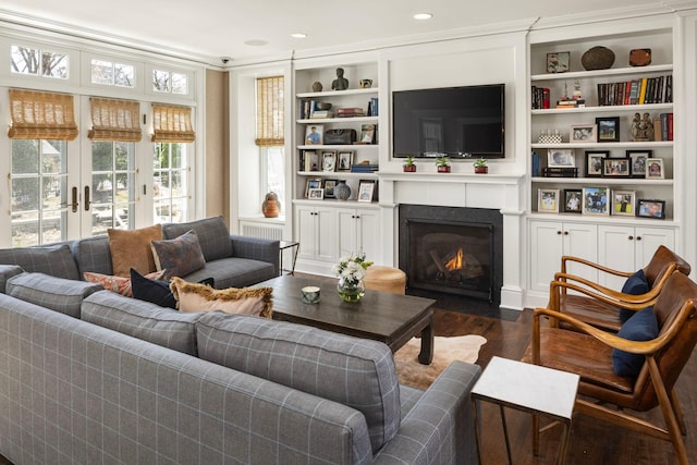 2774 Lake Of The Isles Pkwy, Minneapolis, MN 55416 - living room with dark wood-style floors, a fireplace with flush hearth, crown molding, built in shelves, and recessed lighting