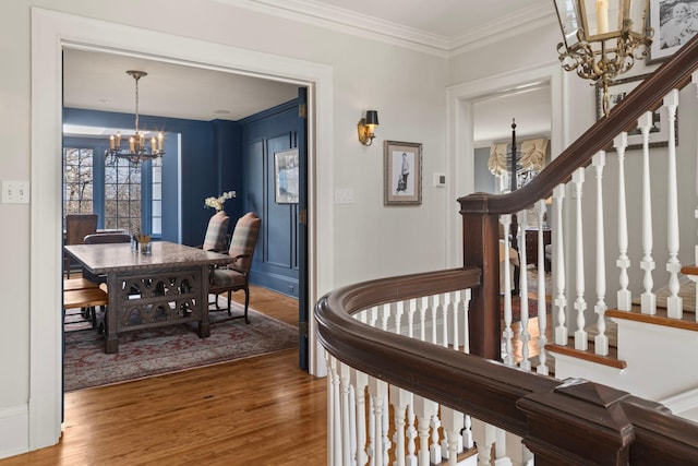 2774 Lake Of The Isles Pkwy, Minneapolis, MN 55416 - stairs with a chandelier, wood finished floors, and ornamental molding
