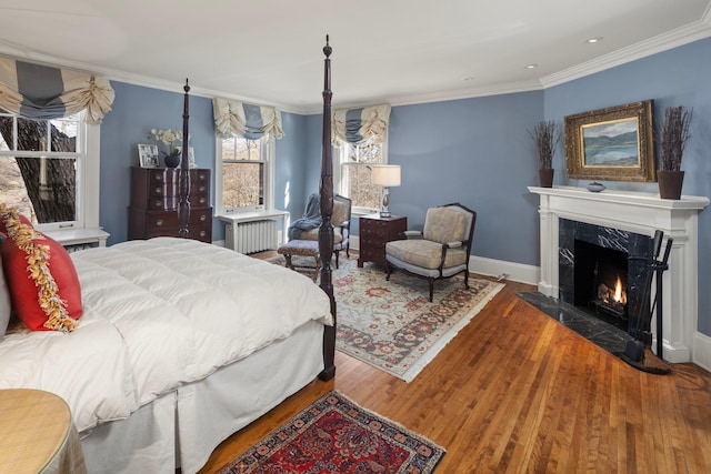 2774 Lake Of The Isles Pkwy, Minneapolis, MN 55416 - bedroom with radiator heating unit, crown molding, wood finished floors, a high end fireplace, and recessed lighting