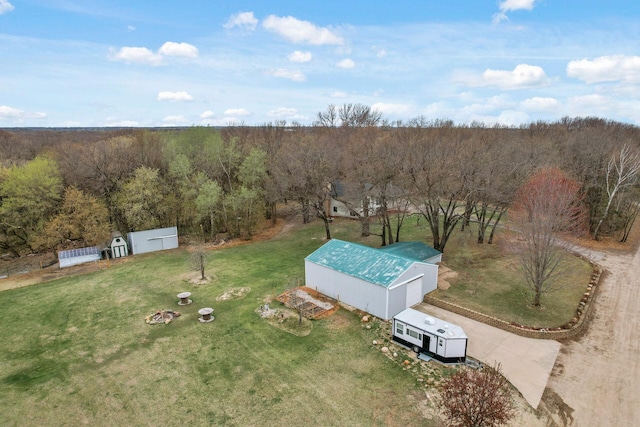 birds eye view of property with a wooded view