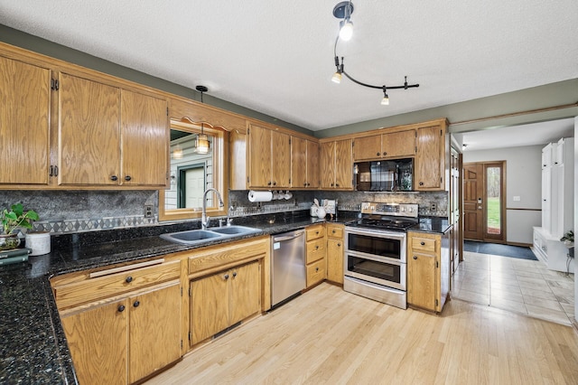 kitchen featuring a sink, a wealth of natural light, stainless steel appliances, and tasteful backsplash