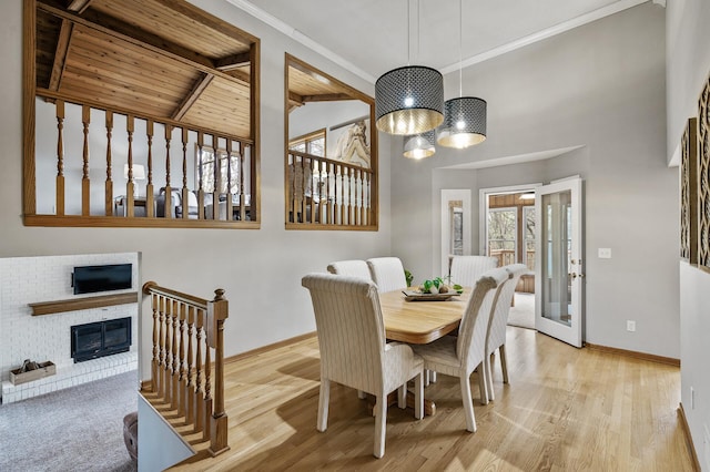 dining room with high vaulted ceiling, beam ceiling, wood finished floors, and baseboards