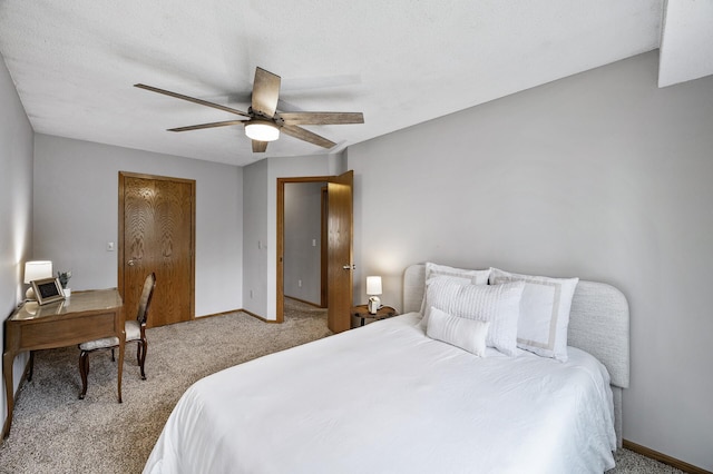 carpeted bedroom with baseboards and a ceiling fan