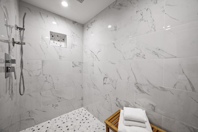 bathroom featuring a tile shower