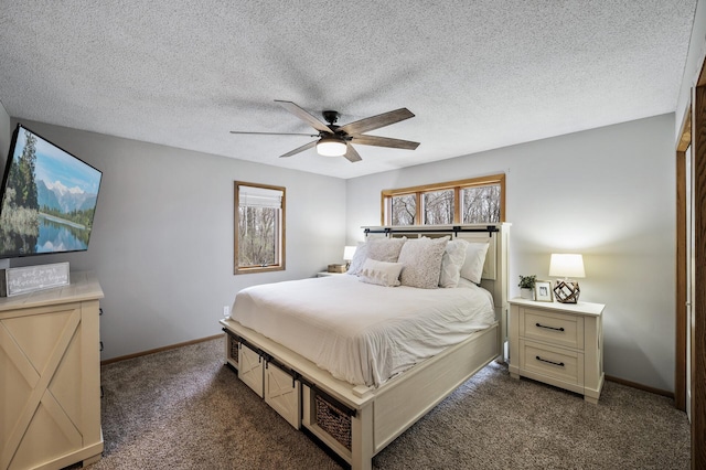 bedroom with a textured ceiling, ceiling fan, dark colored carpet, and baseboards