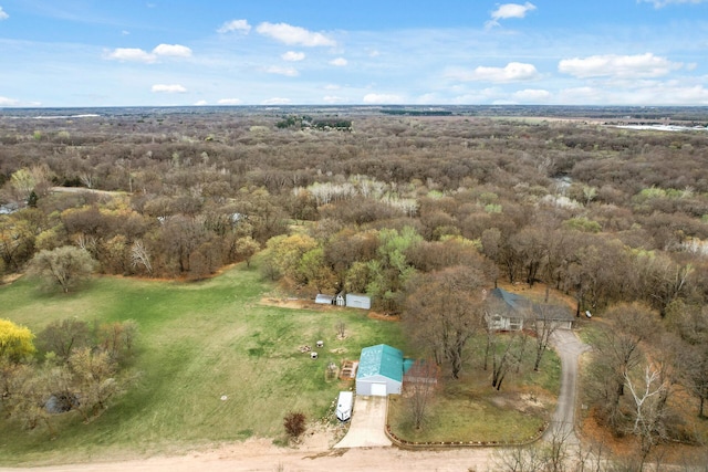 birds eye view of property with a forest view