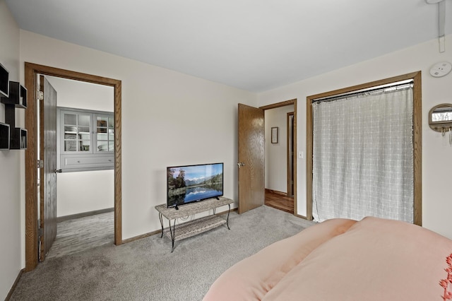 carpeted bedroom with baseboards
