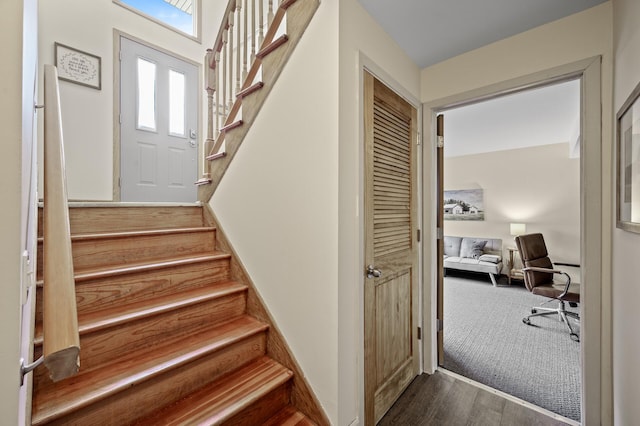stairway with wood finished floors