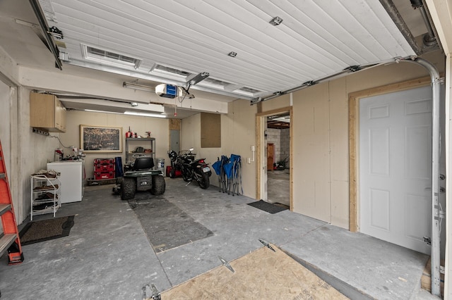 garage featuring a garage door opener and fridge