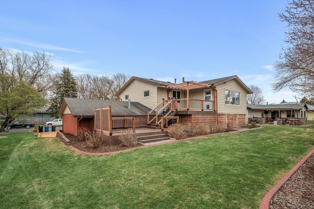 rear view of house featuring a lawn, a wooden deck, and a pergola