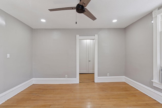 spare room featuring ceiling fan, baseboards, recessed lighting, and light wood-style floors