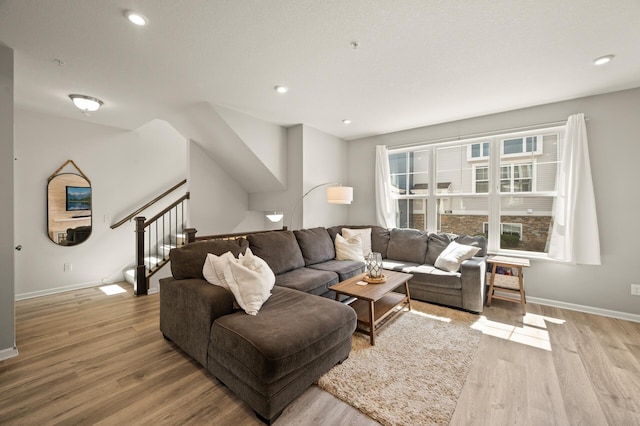 living room with light wood-style flooring, baseboards, and recessed lighting