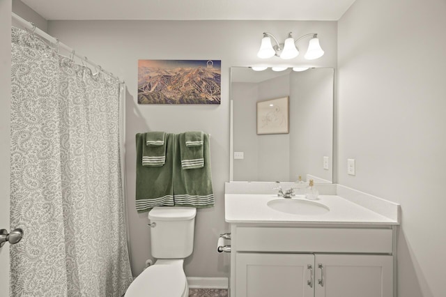 full bath featuring vanity, baseboards, and toilet