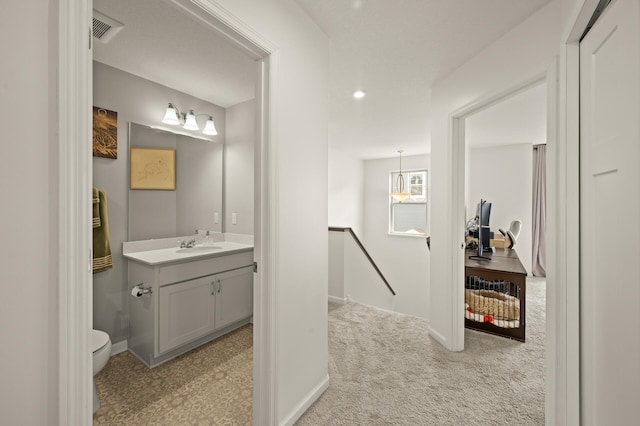 bathroom with vanity, baseboards, recessed lighting, toilet, and visible vents