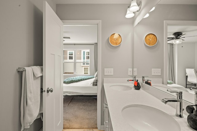 bathroom featuring a sink, ceiling fan, double vanity, and connected bathroom